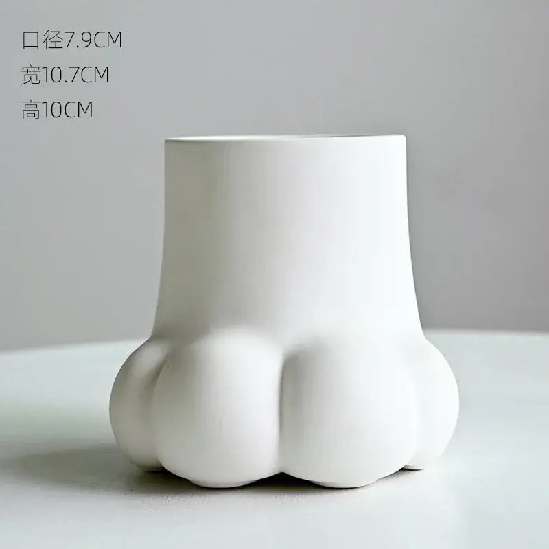 White ceramic planter shaped like a cute cartoon cat paw for living room decor and floral arrangements