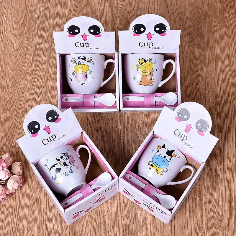 White ceramic cartoon coffee mug set with colorful cow designs and matching pink spoons decorbites cartoon coffee gift