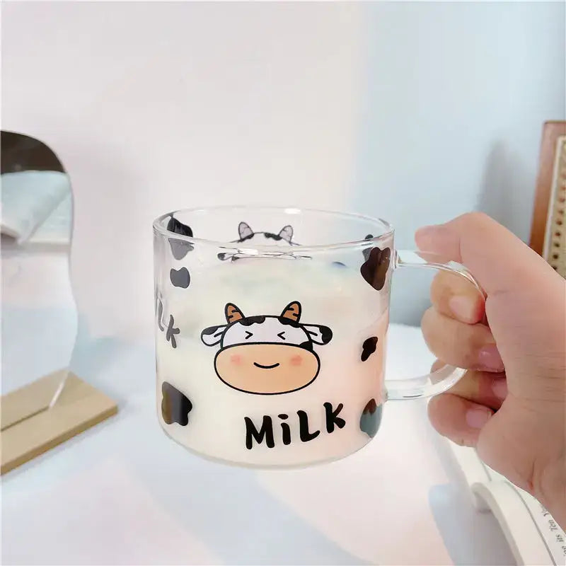 Clear glass mug with spoon lid featuring a cute black spotted cow pattern and milk print for dining room use