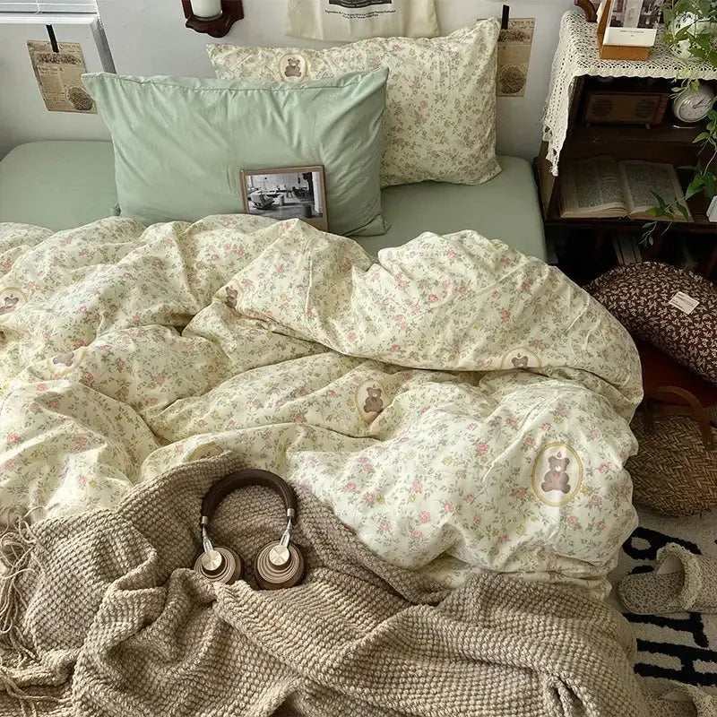 Soft cream floral duvet bedding set with embroidered bear patches and sage green pillows in cartoon washed cotton