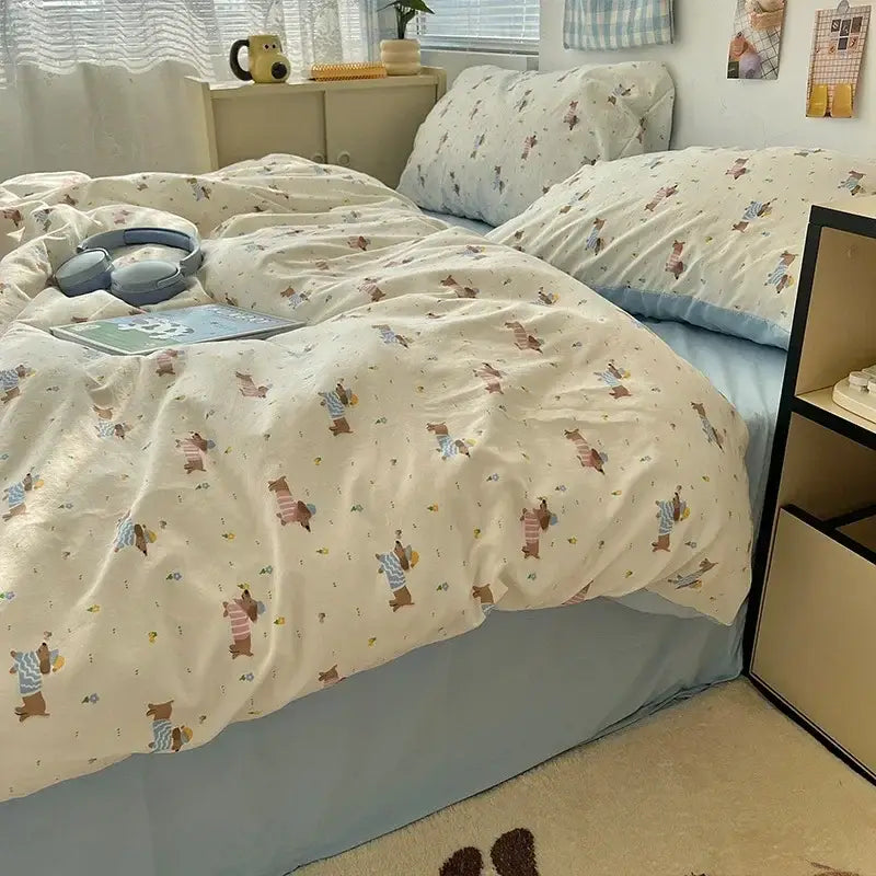 Cream-colored cute cartoon washed cotton bedding set with playful dog pattern paired with light blue pillowcases and bed skirt