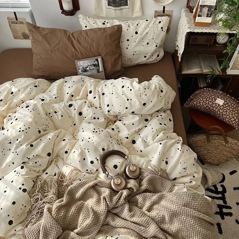 Cream-colored duvet cover with black polka dots in cute cartoon washed cotton bedding set with brown pillow and beige throw