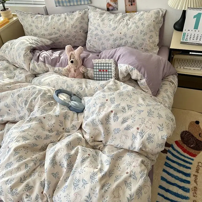 Soft cream-colored duvet cover with blue and gray floral and bunny motifs in cute cartoon washed cotton bedding set