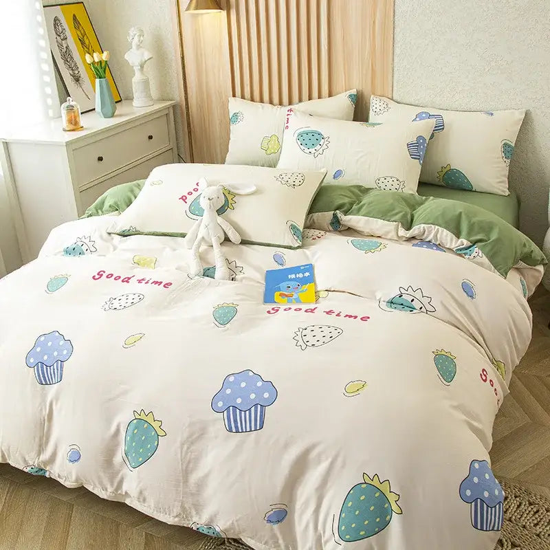 Cream-colored bedding set featuring playful cat bear print with blue polka-dotted cupcakes and teal strawberries on cotton fabric