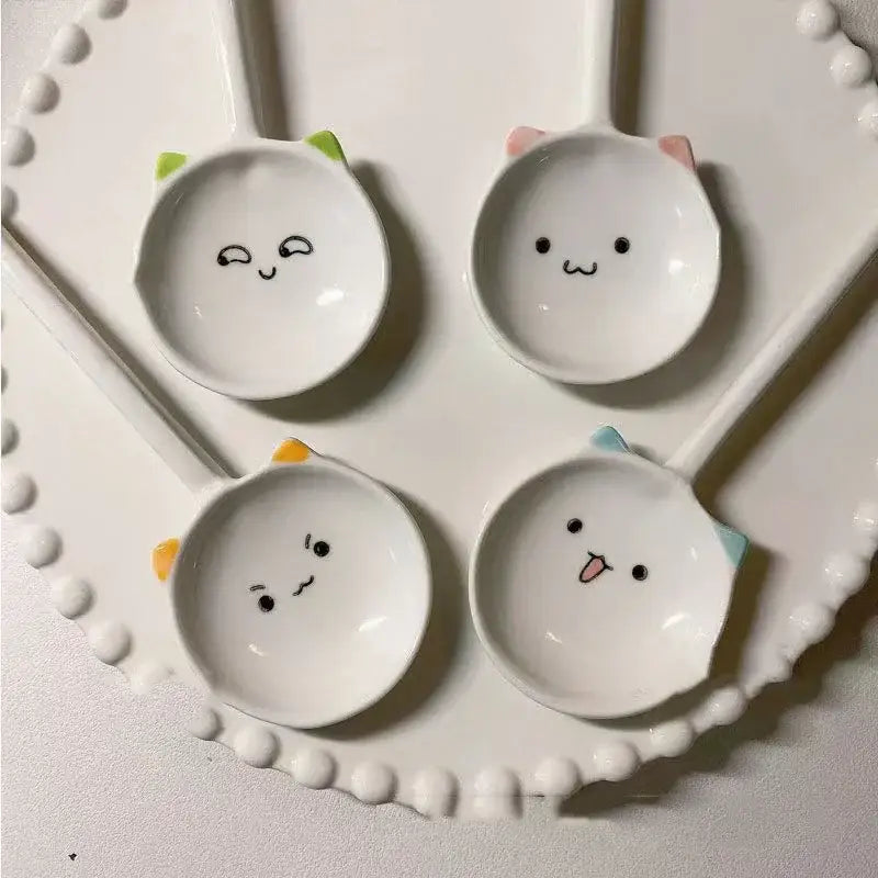 White ceramic cute cat ceramic spoons with colorful ear accents and adorable facial expressions for dessert serving