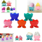 Colorful silicone egg cup holder with cute smiling face design and three-legged base for kitchen breakfast use