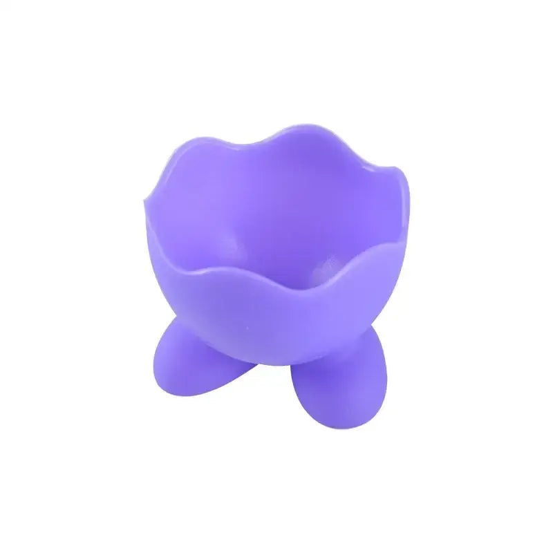 Purple silicone egg cup holder with flower-like rim and three rounded feet for kitchen breakfast use