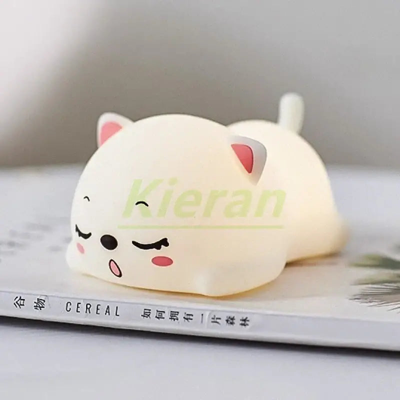 Cream-colored soft silicone cat-shaped stress ball with pink ears and closed eyes for cute cat silicone LED night light decor