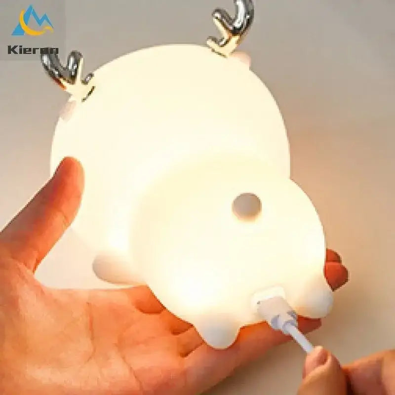 A soft white plush colorful deer led lamp with shiny metallic antlers and usb charging port for bedroom decorbites