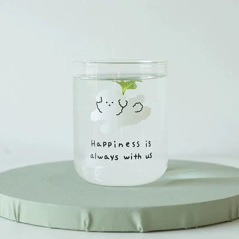 Clear glass cup with a white cartoon cloud and happiness is always with us phrase in a cute dog glass cup design