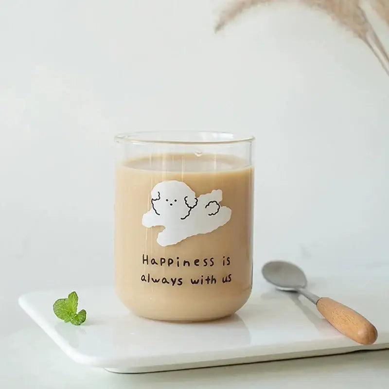 Clear glass cup with a white cloud and happiness is always with us phrase in a cute dog glass cup for kitchen use