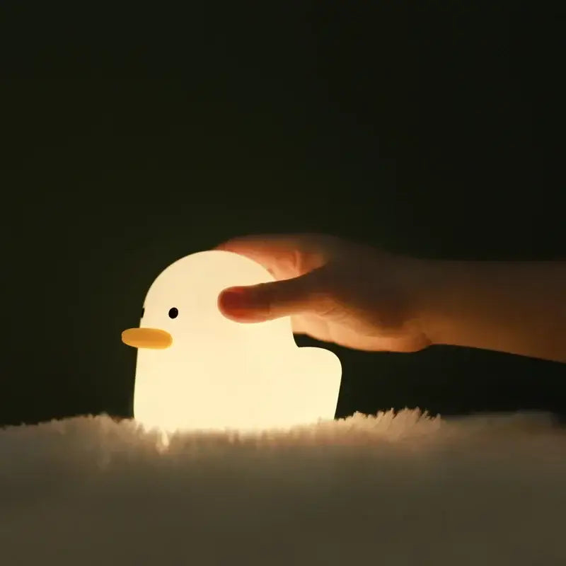 A soft glowing white cute dull duck night light with yellow beak and black eye for bedroom decorbites cute dull decor