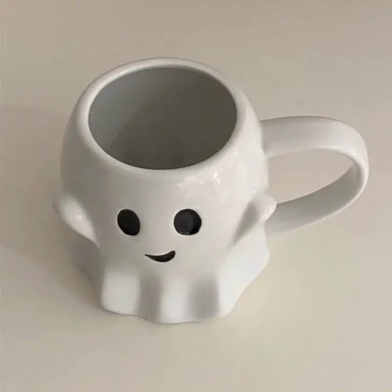 White ceramic mug in a decorbites cute ghost mug set featuring a smiling ghost with black eyes and curved mouth design