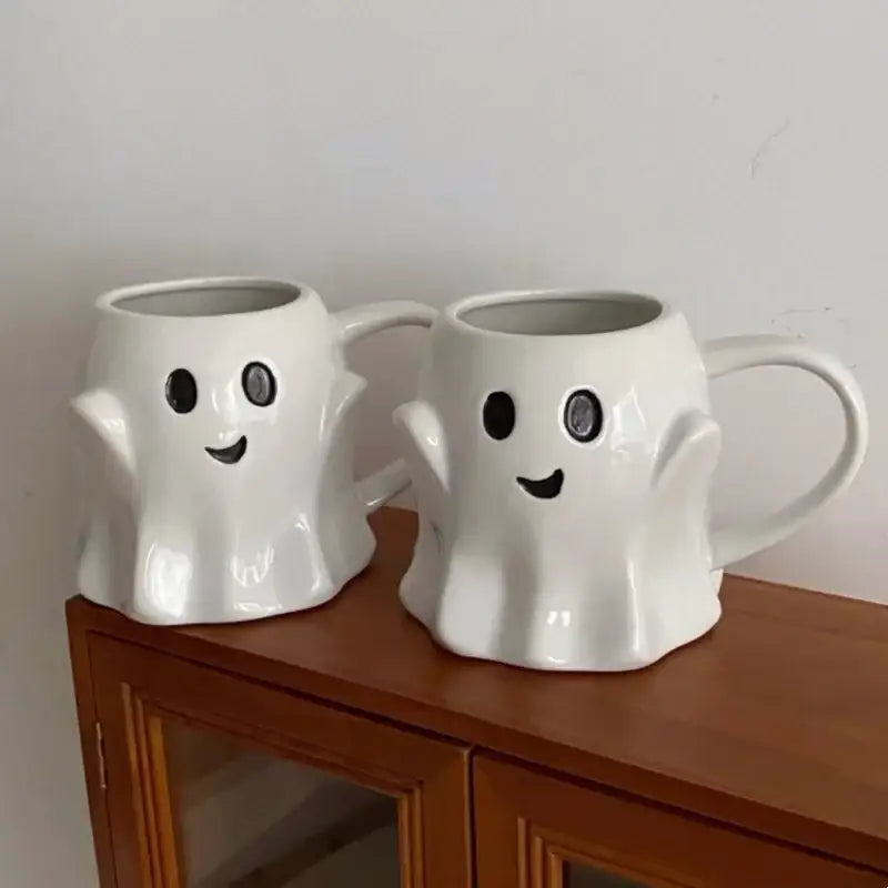 Cute ghost white ceramic mug set featuring ceramic mugs with black smiling faces and circular eyes by decorbites cute ghost
