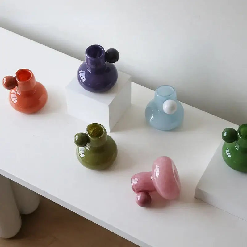 A collection of colorful decorbites cute glass ball candle holders with glossy rounded bodies and spherical handles