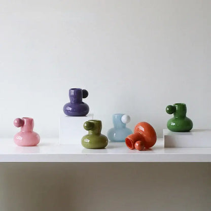 A collection of colorful glossy ceramic candle holders with cute glass ball accents for decorbites cute glass decor