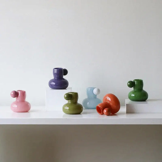 A collection of colorful glossy ceramic candle holders with cute glass ball accents for decorbites cute glass decor