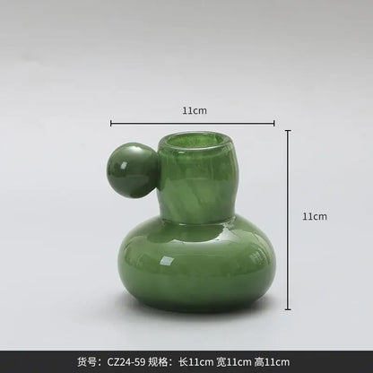 A glossy jade-green ceramic candle holder with a rounded base and small spherical handle for decorbites cute glass ball decor