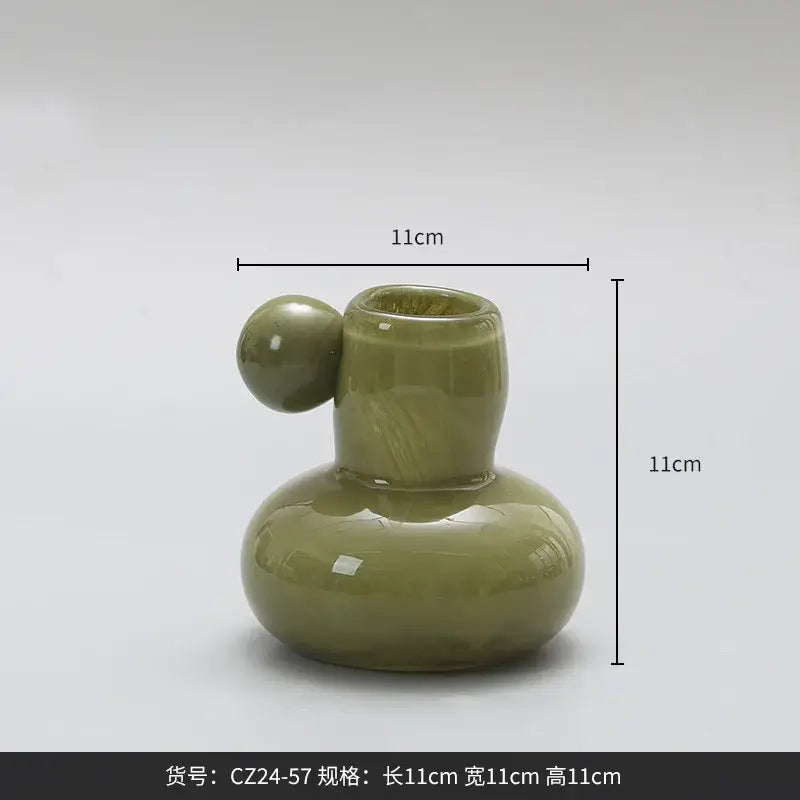 Olive-green ceramic candle holder with rounded base slender neck and spherical handle decorbites cute glass ball decor