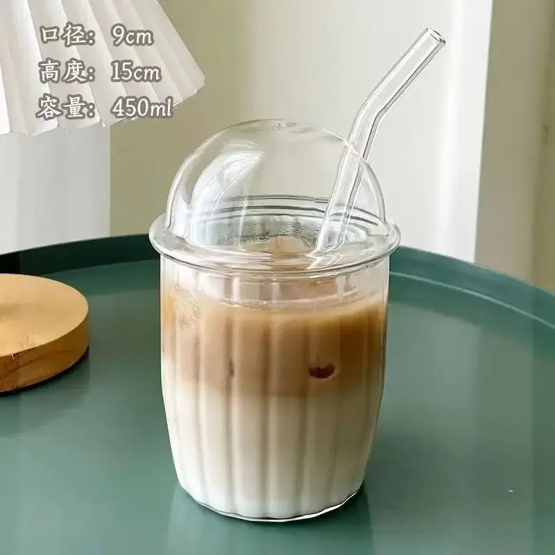 Clear glass cup with fluted sides dome lid and matching straw featuring a pink bow tie for kitchen coffee use