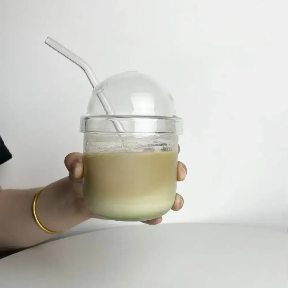 Clear glass cup with dome top and matching curved straw featuring a pink bow tie for kitchen coffee use