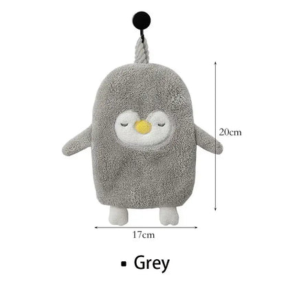 Grey plush penguin-shaped bath sponge with closed eyes yellow beak and white feet paired with decorbites cute goose microfiber hand towels