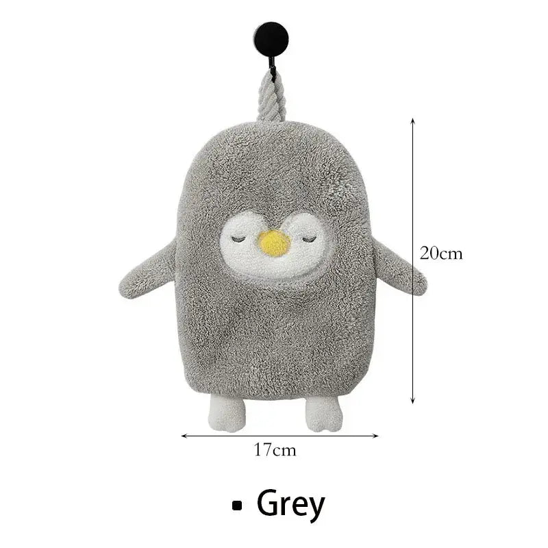 Grey plush penguin-shaped bath sponge with closed eyes yellow beak and white feet paired with decorbites cute goose microfiber hand towels