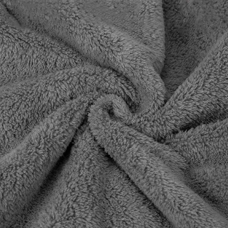 A plush soft gray fleece blanket complements decorbites cute goose microfiber hand towels in white and gray bathroom decor