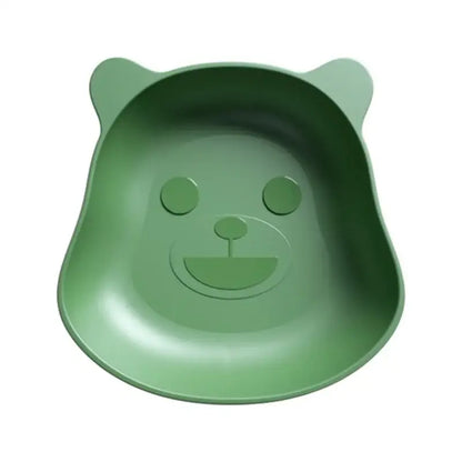 A soft green bear shape plastic fruit plate with rounded ears and a smiling face for kitchen snack use