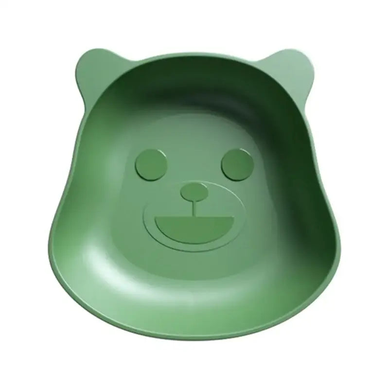 A soft green bear shape plastic fruit plate with rounded ears and a smiling face for kitchen snack use