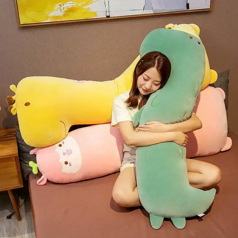 A soft mint green dinosaur sleep body pillow with yellow accents and embroidered facial features by decorbites cartoon animal
