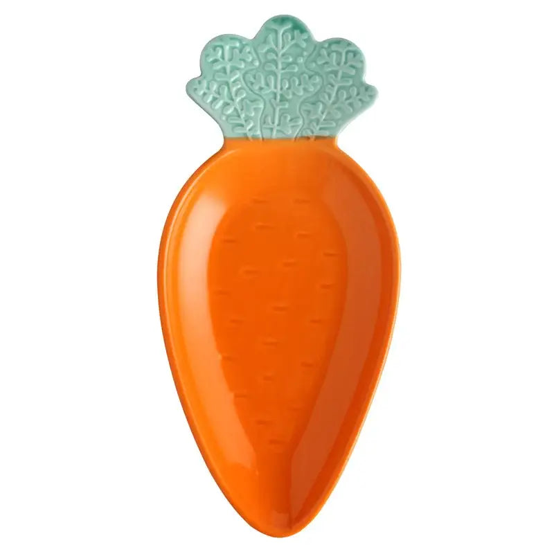 Vibrant orange and green ceramic tableware set featuring a carrot-shaped serving dish with teal leafy top