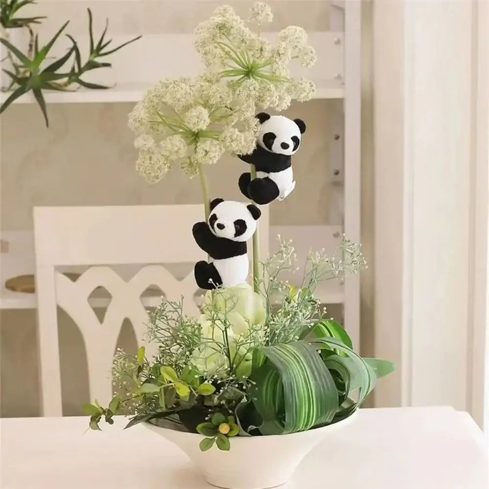 A charming white ceramic bowl with lush greenery and cute panda plush bamboo decorbites cute panda figurines