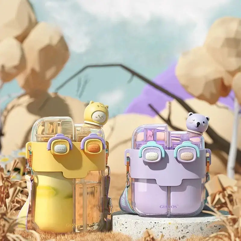 Pastel yellow and lavender double-bin sippy cups with animal-themed lids and colorful straps for kids kitchen use