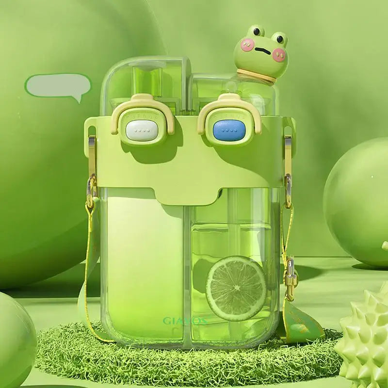 A translucent lime green double-bin sippy cup with a cute frog face and figurine for kids kitchen use