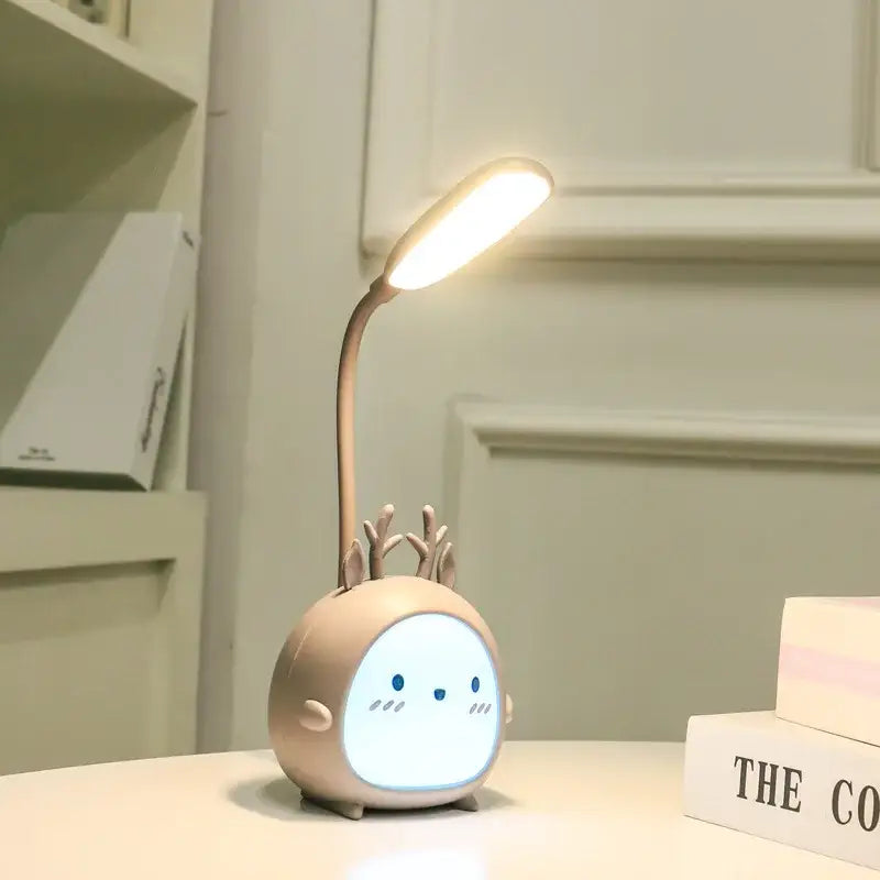A beige cartoon deer led desk lamp with flexible neck and glowing light perfect as decorbites cartoon led night light
