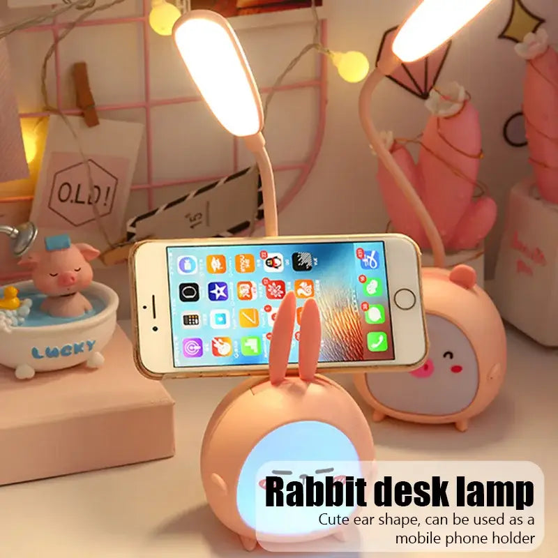 Pink rabbit cartoon led desk night light with glowing blue face and flexible neck designed for smartphone use decorbites cartoon led