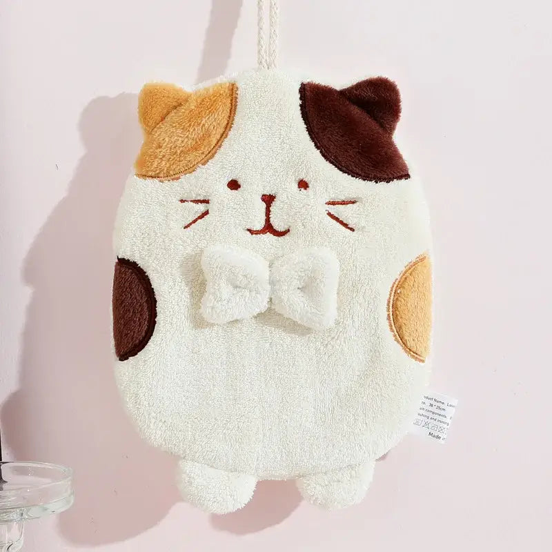 Plush white cat hand towel with brown patches, embroidered features, and a fluffy bow tie for a cute cat hand towel