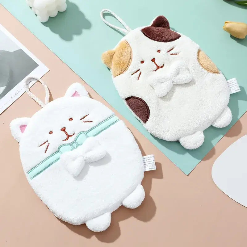 White plush cat hand towel with embroidered face and light blue bow tie made of soft textured bathroom sponge