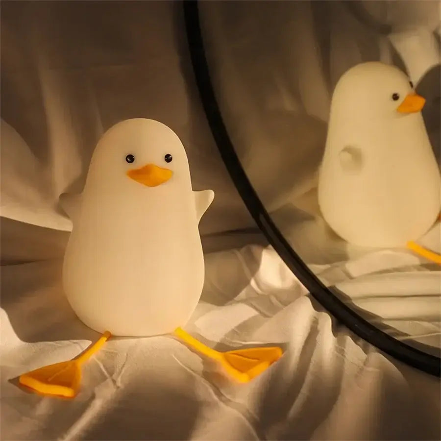 Cute white duck-shaped night lamp made of soft silicone with orange beak and feet usb rechargeable decorbites duck cartoon