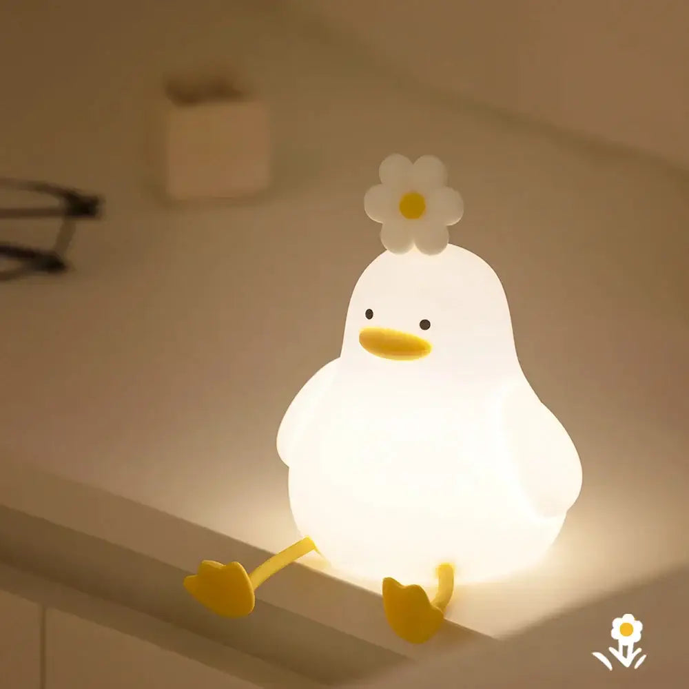 Soft white glowing duck-shaped silicone night light with yellow beak feet and flower decorbites duck cartoon night lamp