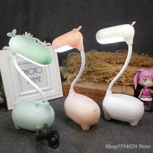 Three cute pig-shaped decorbites elk night lamps in pink white and mint with flexible necks and soft plastic bodies