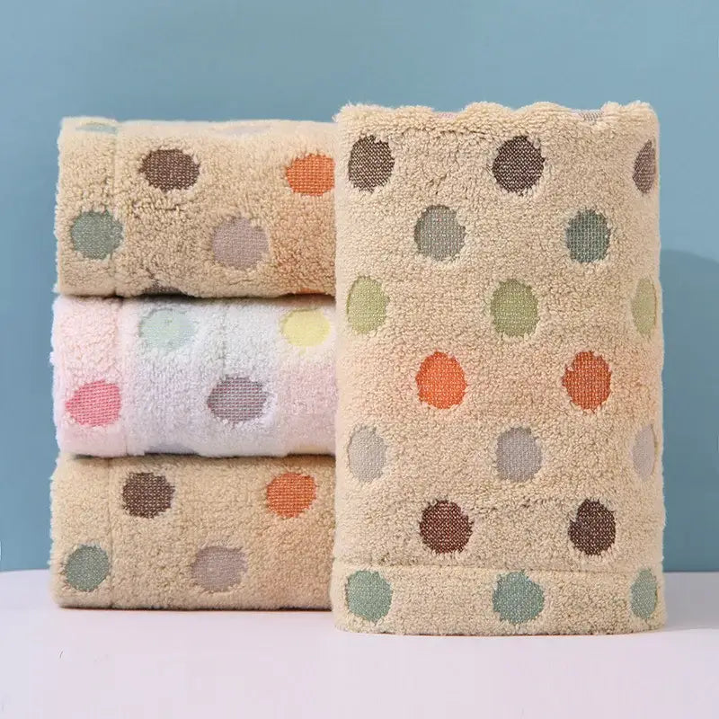 Beige plush cotton dot face towel with multicolored orange green and brown polka dots from decorbites face towel set