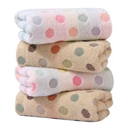 Stack of soft cotton decorbites dot face towels with pastel pink and beige polka dot patterns in a face towel set