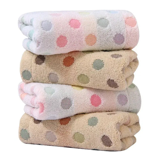 Stack of soft cotton decorbites dot face towels with pastel pink and beige polka dot patterns in a face towel set