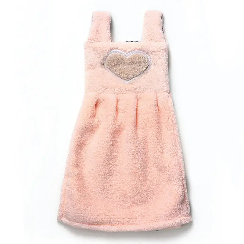 A soft pink terry cloth hand towel dress with a beige heart appliqué for cute cartoon hand towel kitchen decor