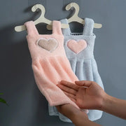 Cute pink and light blue plush cartoon hand towels with heart appliqués hanging on hooks for kitchen decor