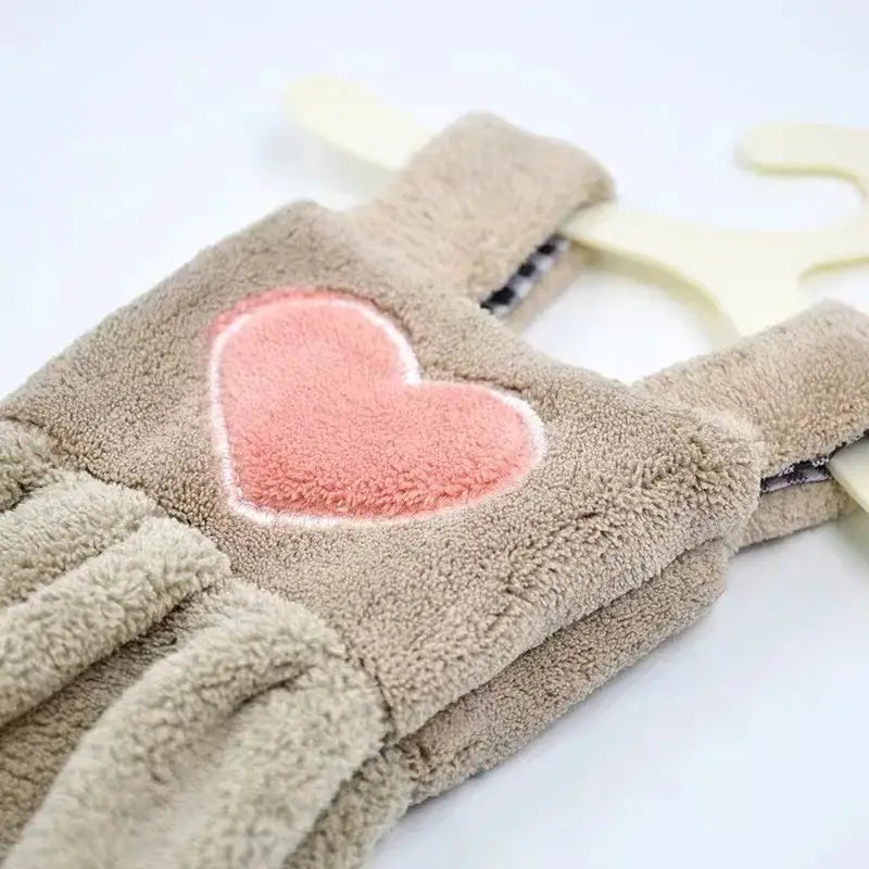 Beige plush fleece overalls with soft pink heart patch in a cute cartoon hand towel for kitchen decor