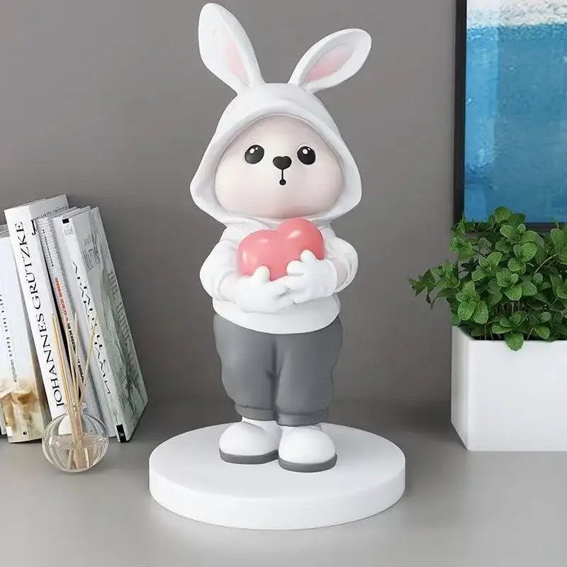 Cute white rabbit desk figurine wearing a hoodie holding a pink heart ideal for bedroom home decor