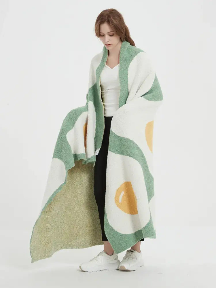 A cozy long white knitted throw poached egg blanket with playful avocado pattern for bedroom decorbites cute poached design